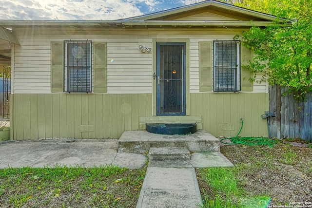 doorway to property with fence