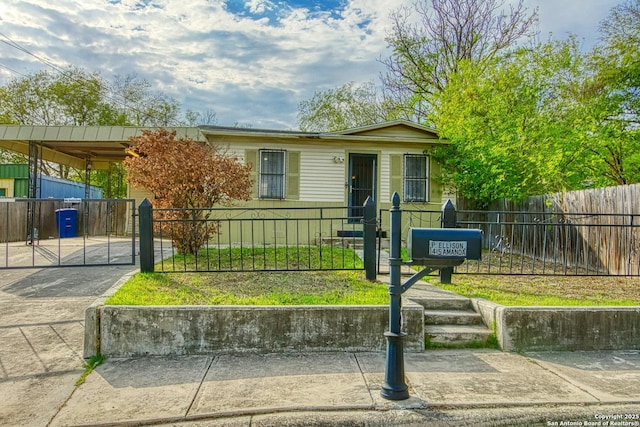 view of front of house with a fenced front yard and a gate