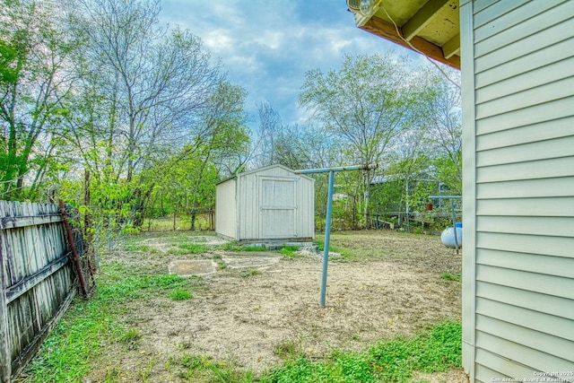 view of yard featuring a fenced backyard, a storage shed, and an outdoor structure