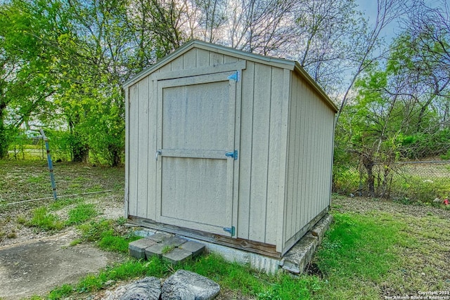 view of shed featuring fence