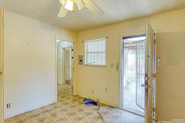 entrance foyer featuring a textured ceiling and ceiling fan