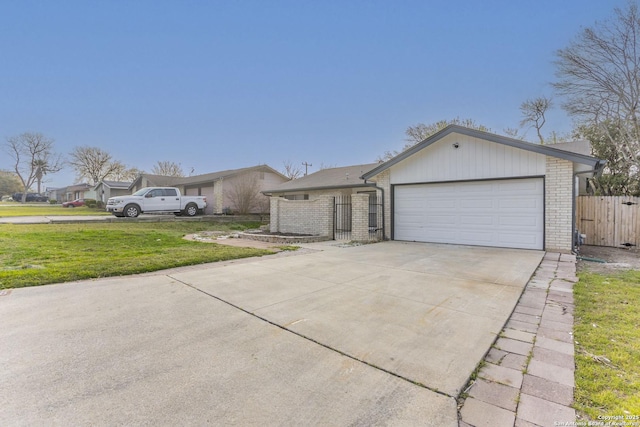 view of front of home with fence, driveway, an attached garage, a front lawn, and brick siding