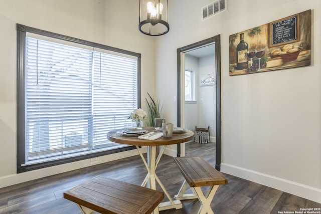 dining room featuring baseboards, visible vents, and dark wood-style flooring