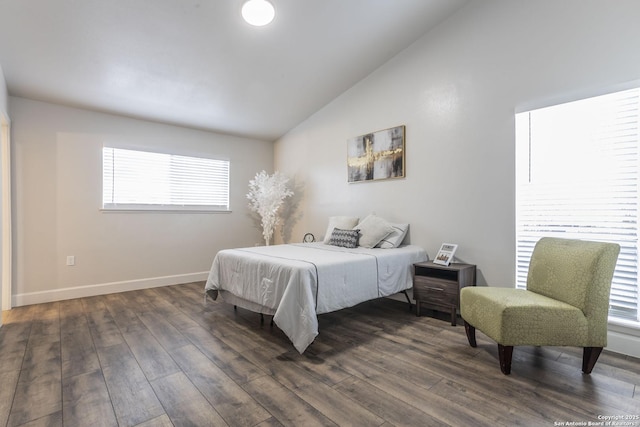 bedroom with vaulted ceiling, dark wood-style floors, and baseboards