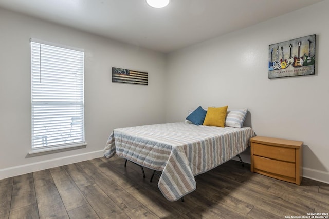 bedroom with wood finished floors and baseboards