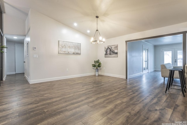 dining area with dark wood-style floors, baseboards, an inviting chandelier, vaulted ceiling, and french doors