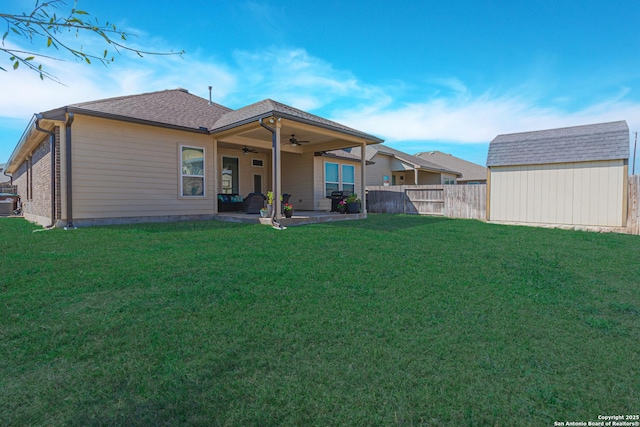 rear view of property with a patio area, a lawn, a ceiling fan, and fence