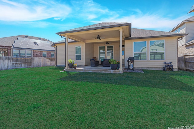 back of property featuring a yard, a patio area, ceiling fan, and fence