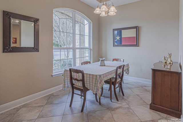 dining room with light tile patterned floors, a notable chandelier, and baseboards