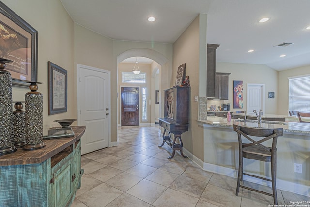 kitchen with visible vents, a healthy amount of sunlight, arched walkways, and butcher block counters