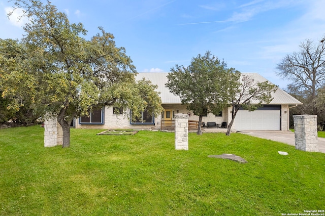 view of front of home with a front lawn, concrete driveway, and an attached garage