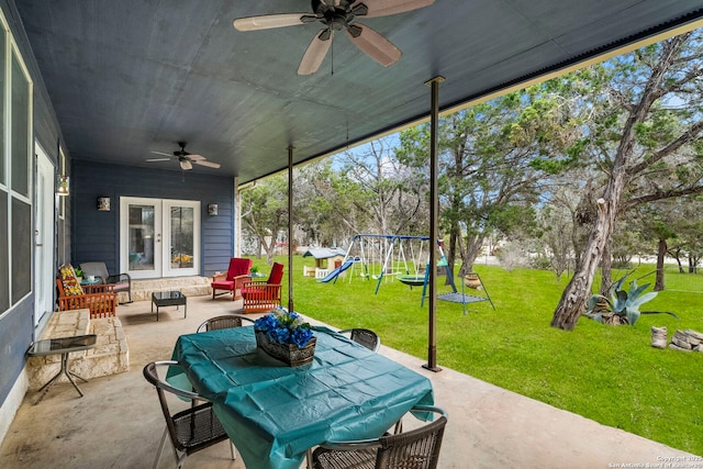 view of patio with french doors, a playground, and ceiling fan