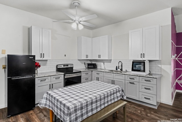 kitchen featuring a sink, backsplash, black appliances, white cabinetry, and dark wood-style flooring