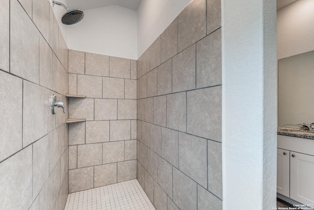 full bathroom featuring vanity and a tile shower