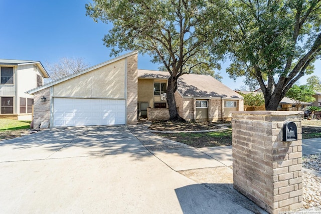 mid-century inspired home featuring stucco siding, concrete driveway, and an attached garage