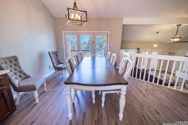 dining room with a notable chandelier, french doors, baseboards, and wood finished floors