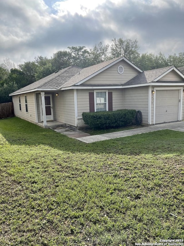 single story home featuring a front lawn, a garage, and a shingled roof