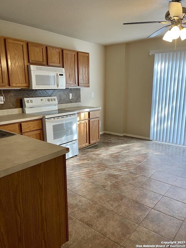 kitchen with white appliances, ceiling fan, decorative backsplash, light countertops, and brown cabinets