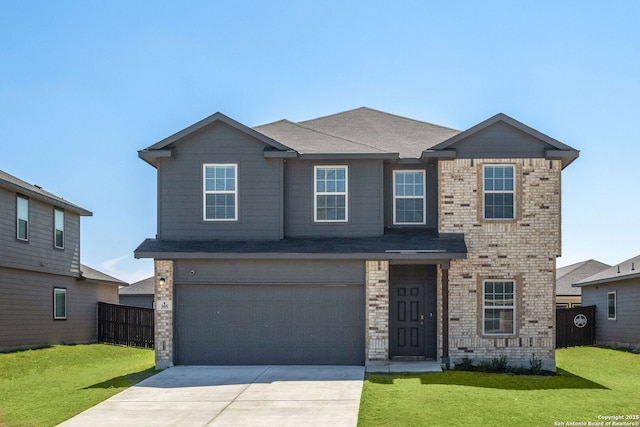 traditional-style home with brick siding, concrete driveway, a front lawn, and fence