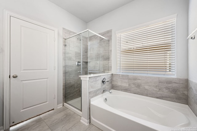 bathroom with a garden tub and a shower stall