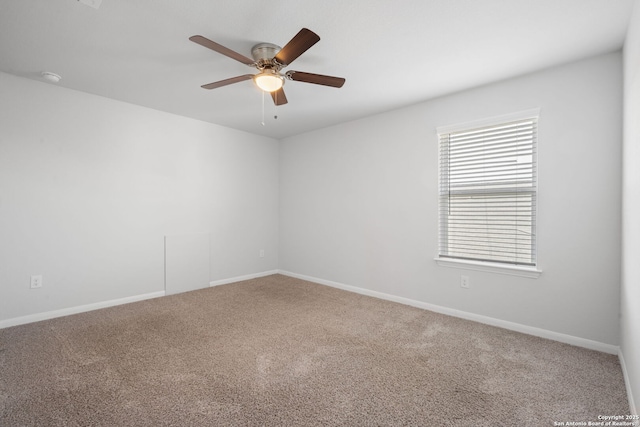 carpeted empty room with baseboards and ceiling fan