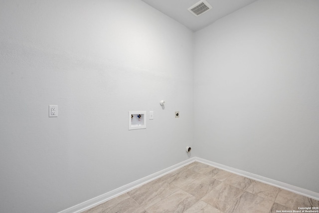 clothes washing area featuring electric dryer hookup, visible vents, baseboards, hookup for a washing machine, and laundry area