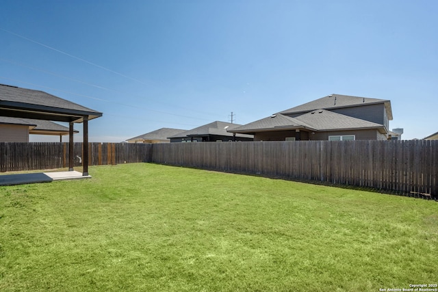 view of yard with a fenced backyard