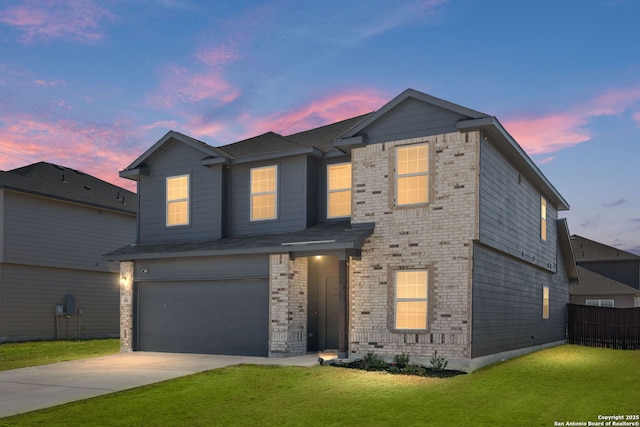 traditional-style home featuring a yard, brick siding, driveway, and fence