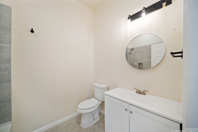 bathroom with tile patterned floors, toilet, vanity, and baseboards