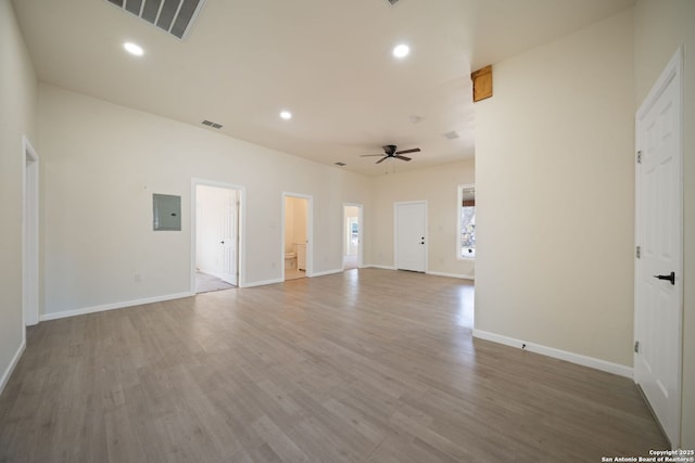 empty room featuring electric panel, recessed lighting, wood finished floors, and a ceiling fan