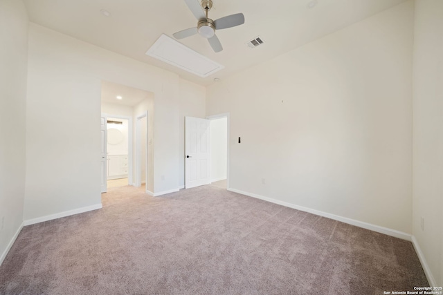 spare room with light carpet, visible vents, baseboards, and ceiling fan