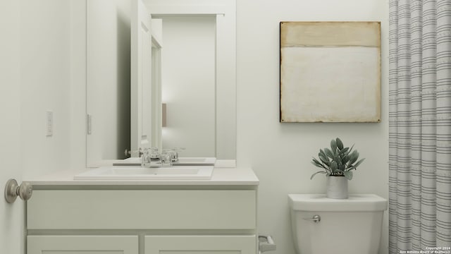 bathroom with vanity, a shower with shower curtain, and toilet
