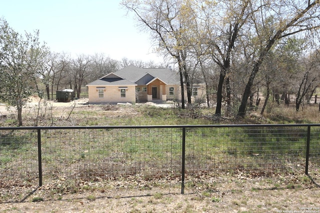 view of front facade featuring fence private yard and a shingled roof