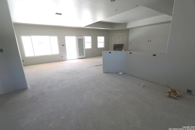 spare room with visible vents, a healthy amount of sunlight, and a tray ceiling