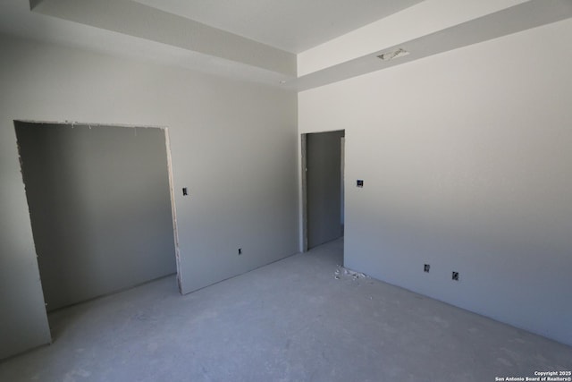 unfurnished room with a tray ceiling