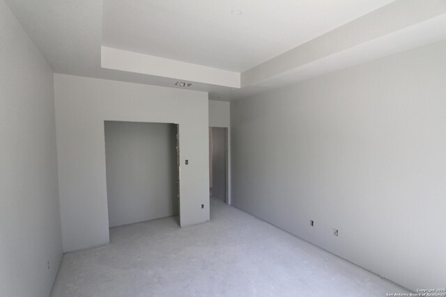 unfurnished bedroom featuring a raised ceiling