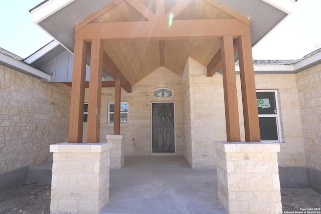 view of exterior entry featuring stone siding