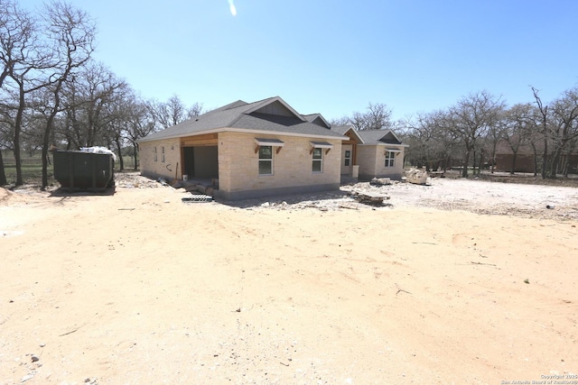 back of house featuring a garage