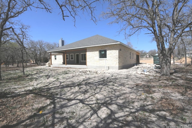 back of property with a chimney