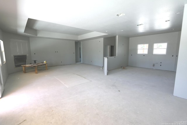 spare room featuring a raised ceiling and a fireplace