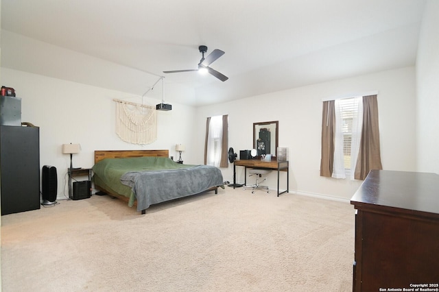 carpeted bedroom featuring multiple windows, baseboards, and ceiling fan