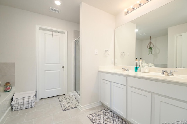 full bath featuring visible vents, a shower stall, and a sink