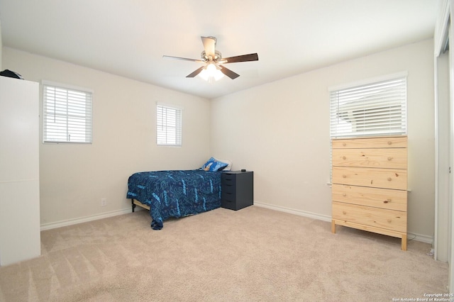 carpeted bedroom with baseboards and ceiling fan