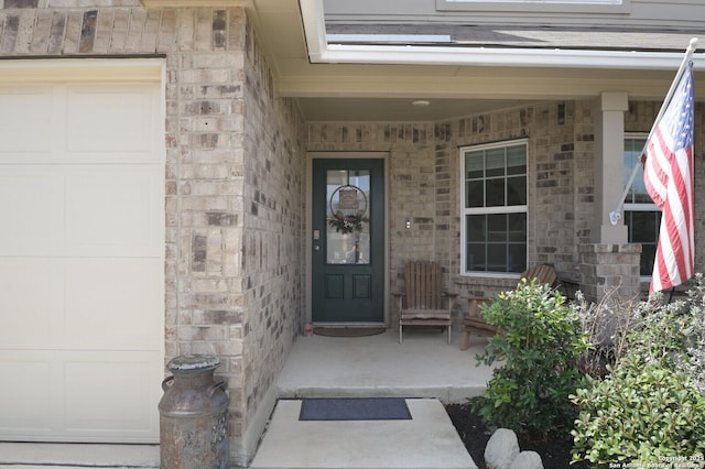 doorway to property featuring stone siding and covered porch