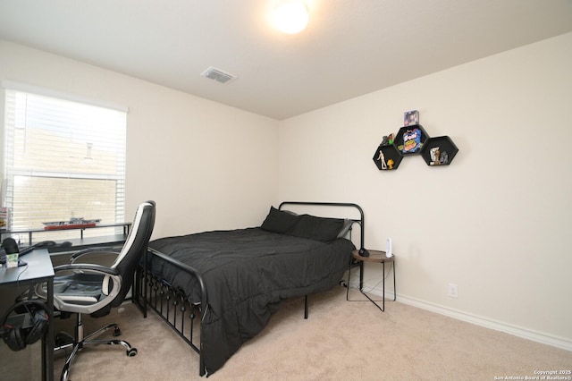 carpeted bedroom with visible vents and baseboards