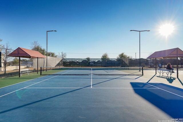 view of sport court featuring fence