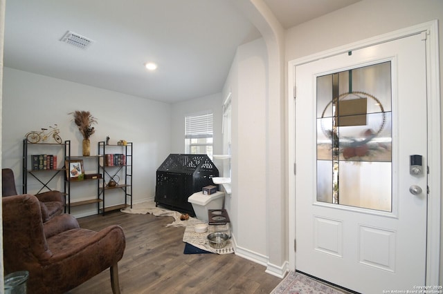 interior space with dark wood finished floors, visible vents, and baseboards