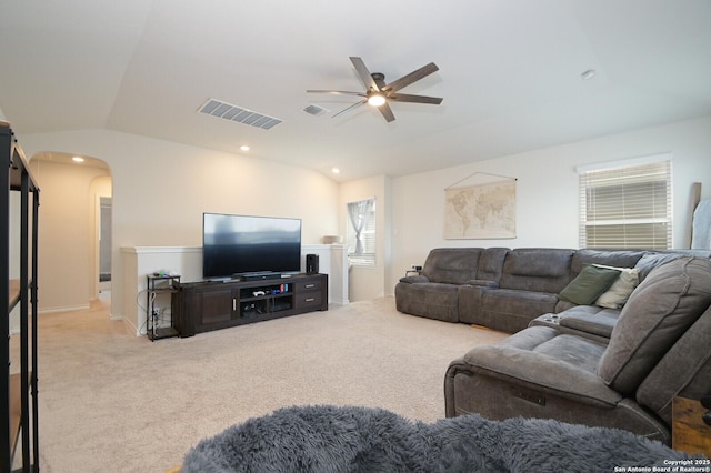 carpeted living area featuring visible vents, lofted ceiling, recessed lighting, arched walkways, and a ceiling fan