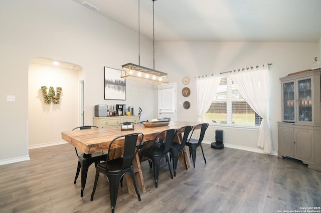 dining area with visible vents, baseboards, and wood finished floors