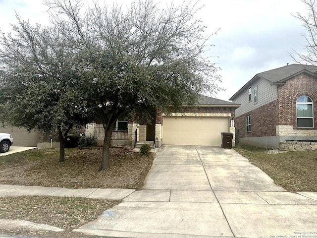 obstructed view of property featuring a garage, brick siding, and concrete driveway